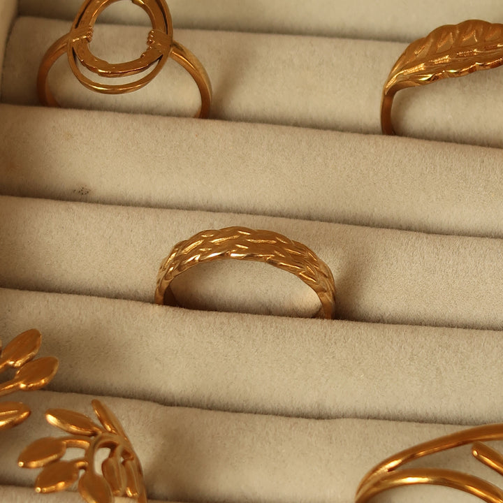 Woven ring in gold on a velvet tray
