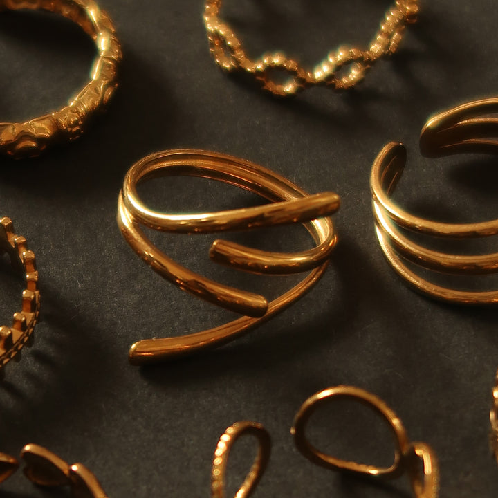 Held ring in gold on a velvet tray