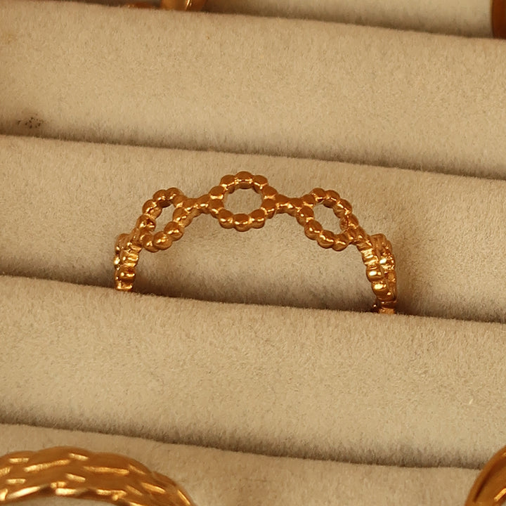 Linked ring in gold on a velvet tray