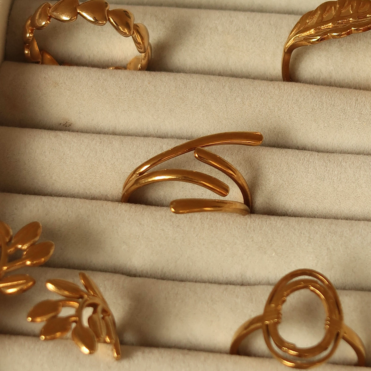 Held ring in gold on a velvet tray #Color_Gold