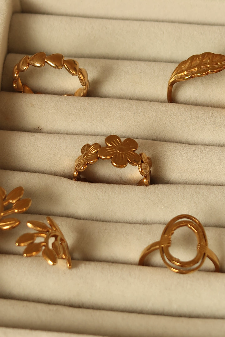 Bloom ring in gold on a velvet tray