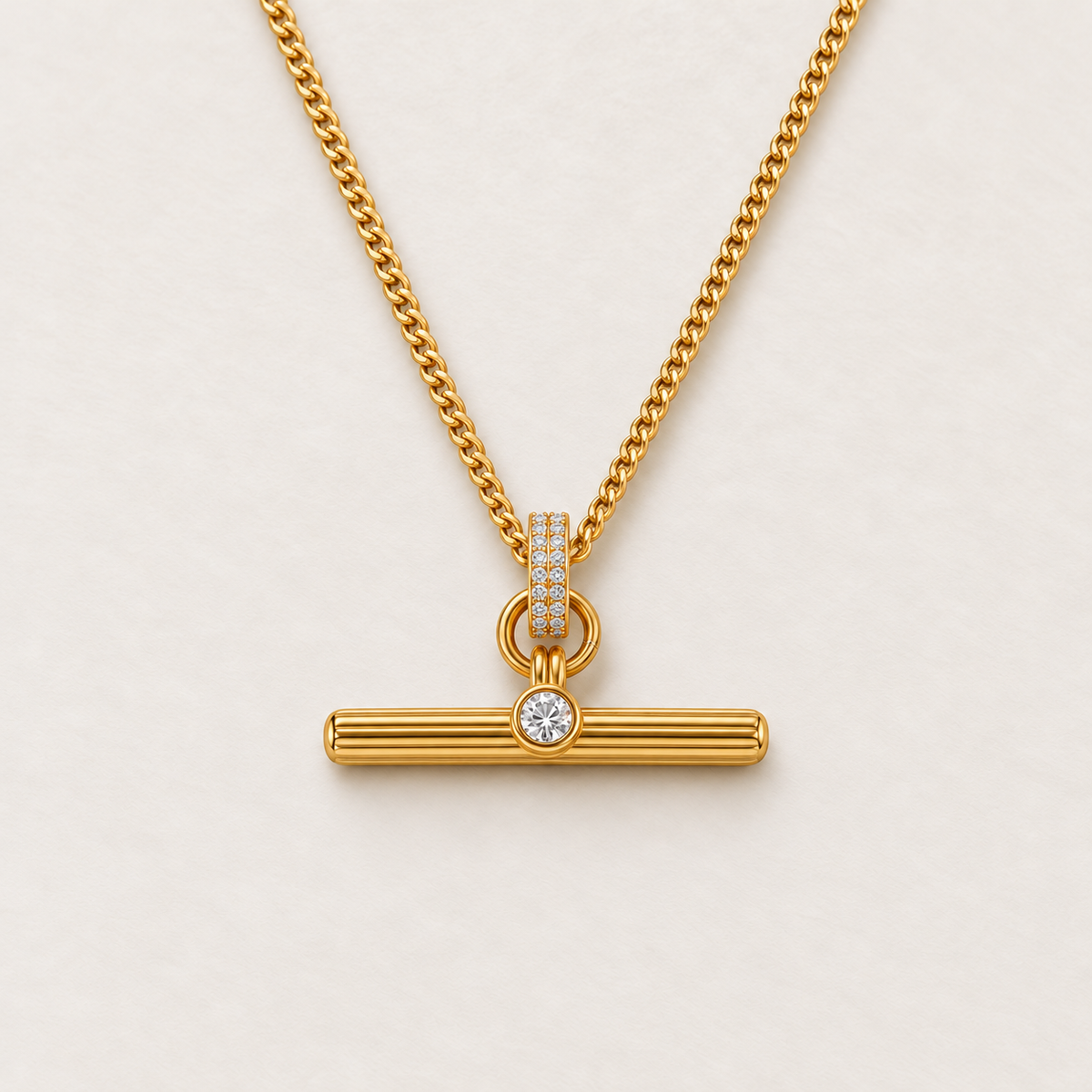 Albertina T-Bar Necklace in gold, Pavé style: fine curb chain, pavé bail with two rows of clear stones and a fluted T-bar with a single round stone